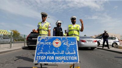 Police and security officials stand guard at a checkpoint on a highway in Sanabis west of Manama, Bahrain on February 9, 2017. Hamad I Mohammed/Reuters