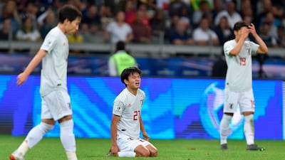 Japan's Takefusa Kubo, centre, looks dejected after a 1-1 draw against Ecuador saw both teams exit the 2019 Copa America. AFP