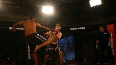 Amin Sherifi, left, and Craig Harriman fight during the Dubai Fighting Championship. Satish Kumar / The National