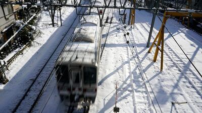 This picture, taken on January 23, 2018, shows a train on rail tracks covered with snow in Tokyo, Japan. Franck Robichon / EPA
