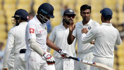Ravichandran Ashwin, second from right, was the pick of India's bowlers on Friday. Rajanish Kakade / AP Photo