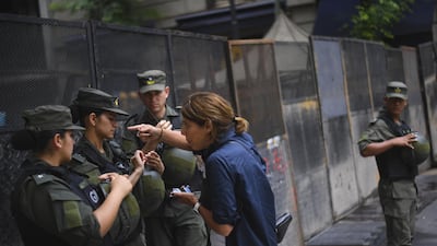 A resident talks to members of National Gendarmerie at a road block. EPA