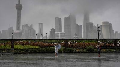People pose for a photo along an empty Bund in Shanghai.
