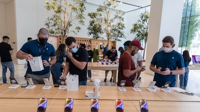 iPhone 14 units are seen at the Apple Store in The Dubai Mall. The company on Thursday reported that net profit for its fiscal third quarter rose 2.3 per cent annually to more than $19.8 billion, despite the company reporting a yearly drop in total sales. Antonie Robertson / The National