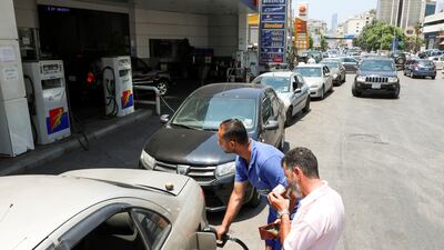 A worker fills up a car with fuel at a gas station in Beirut.
