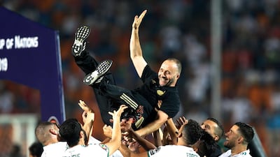 Algeria's players throw their manager Djamel Belmadi in celebration. AP