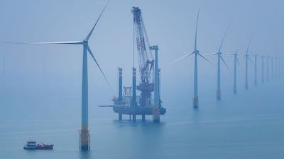 Wind turbines in China. Rising demand has slowed down progress on energy efficiency, says the head of the UN’s renewable energy agency. AFP
