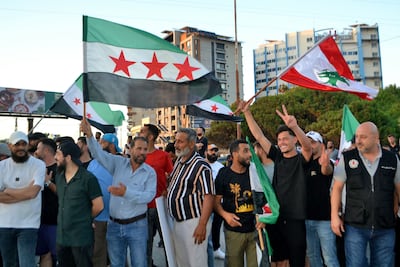 People wave Syrian and Lebanese flags during a visit by Syrian Foreign Minister Asaad Al Shibani in Tripoli, Lebanon, on July 2. AFP