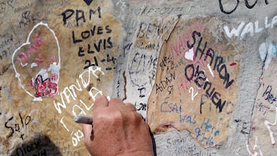 Fans continue to leave love notes to Elvis on the wall of Graceland as mourners gather to commemorate the 40th anniversary of the death of singer Elvis Presley at his former home of Graceland, in Memphis, Tennessee. Karen Pulfer Focht / Reuters