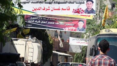 Banners celebrating a Lebanese fighter, who died fighting alongside Syrian government forces battling rebels, hang above a street Baalbek. The Lebanese government has started a campaign to remove such posters in a bid to reduce tensions. AFP PHOTO