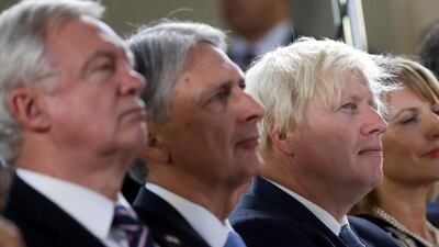 David Davis, Philip Hammond and Boris Johnson listen to Theresa May's Brexit speech in Florence in 2017. Mr Hammond says Mr Johnson must bring hard Brexit colleagues in to line after the election. Alessandra Tarantino / Reuters