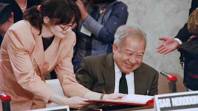 Cambodia's Prince Norodom Sihanouk signs the agreement during the Cambodia Peace Conference in Paris. AFP