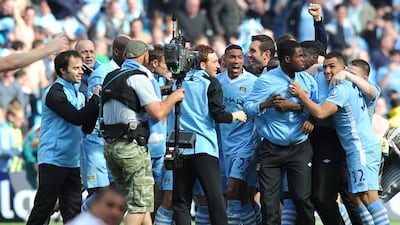 Manchester City's players and supporters celebrate the win over QPR. AFP