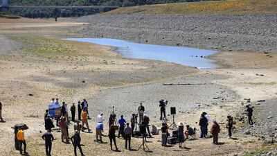 Gavin Newsom holds a conference in the parched basin of Lake Mendocino in Ukiah, California, where he announced a drought emergency for Mendocino and Sonoma counties. Kent Porter / The Press Democrat via AP