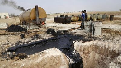 A makeshift oil refinery in Marchmarin town, Idlib, Syria. The operation’s owner gets the crude from ISIL-controlled areas in Deir Ezzour province and Iraq. Khalil Ashawi / Reuters