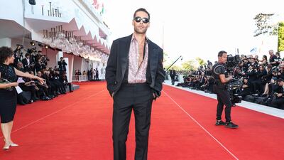 Jon Kortajarena wears a slick suit with an open satin shirt. Getty Images