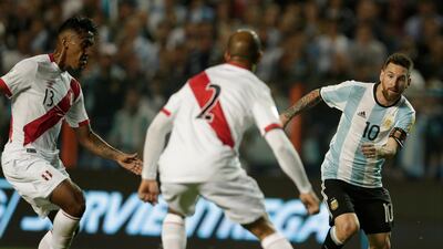 Argentina's Lionel Messi, right, fights for the ball with Peru's Alberto Rodriguez, center, and Renato Tapia during a World Cup qualifying soccer match at La Bombonera stadium in Buenos Aires, Argentina, Thursday, Oct. 5, 2017. (AP Photo/Victor R. Caivano)
