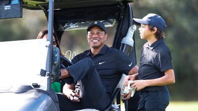 Tiger Woods sits in a cart alongside his son Charlie during the first round of the PNC Championship in Orlando. AP
