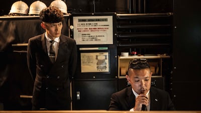 A supervisor from the Tokai University 'oendan', right, speaking during a Tokyo competition between university cheerleading squads