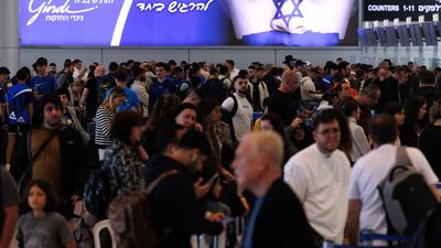 Passengers wait to check-in in the departure terminal in Ben Gurion airport on the morning after a drone and missile attack from Iran. Bloomberg