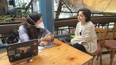 Maya Tabbara sitting with Melissa Fathallah, a volunteer with Beytna Beytak, at Em Nazih hostel in Gemmayze, Beirut. Sunniva Rose for The National