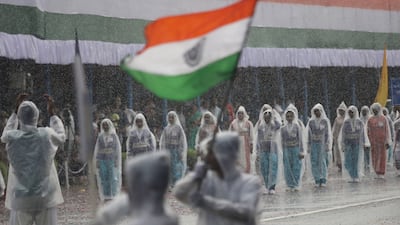 Students are undaunted by heavy rain as they parade on Independence Day in Kolkata. EPA