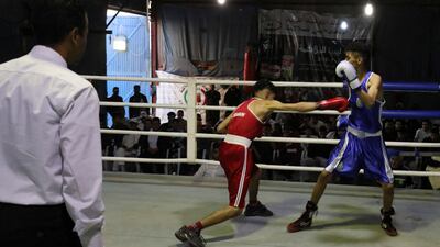 A boxing match in Tripoli. Libya's previous regime considered boxing too violent but, since the 2011 revolution, the country's fighters have shone in various competitions. Many are modelling themselves after Malik Zinad, a light heavyweight boxer who found success after leaving the country for Europe. All photos: AFP
