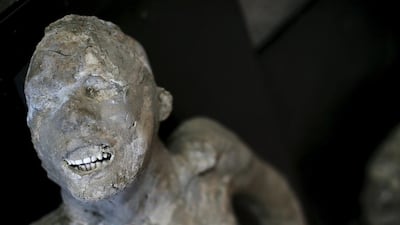 The plaster cast of a Pompeii victim lies in a frescoed room. Alessandro Bianchi / Reuters