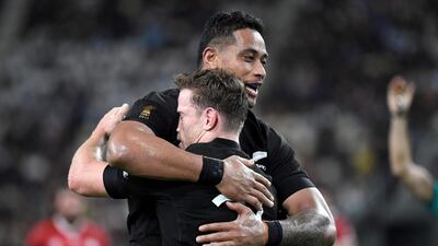 New Zealand's scrum-half Brad Weber, right, celebrates after scoring a try during the Rugby World Cup Pool B match against Canada at the Oita Stadium. AFP