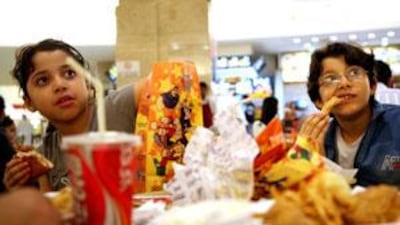 Happy eating: Nouran Al Deen and Ahmad Al Deen tackle a tempting spread in a popular Abu Dhabi restaurant.