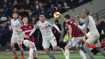 West Ham's Declan Rice in action with Liverpool's Roberto Firmino. Reuters