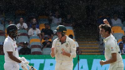 Pat Cummins and Marnus Labuschagne celebrate the wicket of Cheteshwar Pujara. AFP