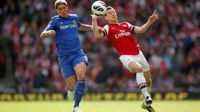 Arsenal's Laurent Koscielny, right, competes for the ball with Chelsea's Fernando Torres.