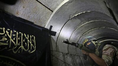 This file photo taken on March 03, 2015 shows A Palestinian militant from the Islamic Jihad's armed wing, the Al-Quds Brigades, standing in a tunnel, used for storing weapons, as he takes part in military training in the south of the Gaza Strip on March 3, 2015. A report re;leased on February 28, 2017, has criticised prime minister Benjamin Netanyahu and military leaders for insufficiently preparing for attack tunnels in the 2014 Gaza war. Mahmud Hams /AFP