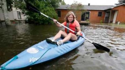 Ruth Breland kayaks from the backyard of her home on Dog River Drive South as heavy rains and water from the river flooded their neighborhood as Hurricane Gustav hit along the Gulf Coast on Sept 1.