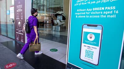 Al Hosn Green Pass signs at the Al Wahda Mall in Abu Dhabi. Victor Besa / The National.