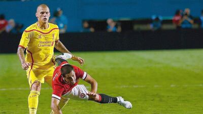 Javier Hernandez, right, of Manchester United is tackled by Martin Skrtel of Liverpool during the International Champions Cup final at Sun Life Stadium on August 4, 2014, in Miami Gardens, Florida. Hernandez is one of several United players who could leave the squad before the Premier League season begins. Chris Trotman / Getty Images