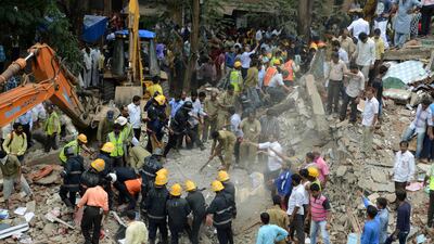 Indian rescue workers look for survivors in debris at the site of a building collapse in Mumbai on July 25, 2017. AFP / Punit Paranjpe