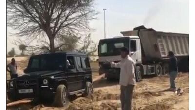 Sheikh Hamdan helps pull a lorry stuck in the desert. Instagram screengrab