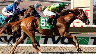 In this photo provided by Benoit Photo, Donegal Racing's Dullahan and jockey Joel Rosario, right, fly by Game On Dude (Chantal Sutherland), left, to win the Grade I $1,000,000 Pacific Classic horse race, Sunday, Aug. 26, 2012, at Del Mar Thoroughbred Club in Del Mar, Calif. (AP Photo/Benoit Photo)