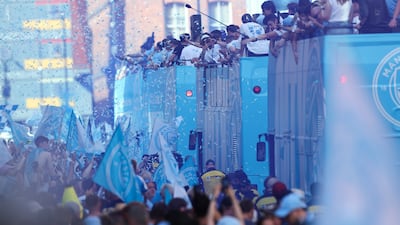 Manchester City players take part in an open-top bus parade celebrating a successful season that included the League Cup and FA Cup, while the women's team clinched the WSL title. EPA