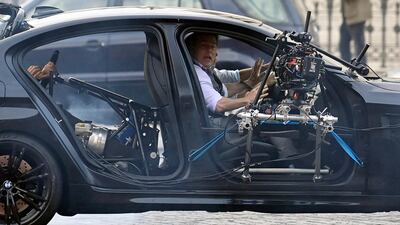 Tom Cruise performs a stunt during the shooting of 'Mission: Impossible 7' at Piazza Venezia in Rome, Italy on November 29, 2020. EPA