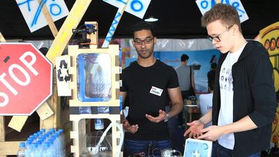 Jagan Narayanan and Steffen Holter, explain their water recycling project to visitors. Ravindranath K / The National