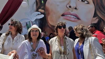 Italo-Tunisian actress Claudia Cardinale (2nd-L) walks through the city of La Goulette near the Tunisian capital on May 29, 2022, during an event honouring the actress in her birth city. (Photo by FETHI BELAID / AFP)