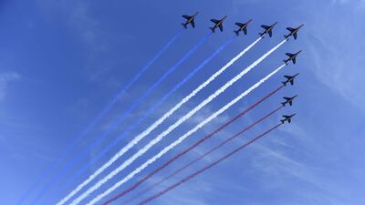 French fighter jets fly over the Champs-Elysees . Saul Loeb / AFP Photo