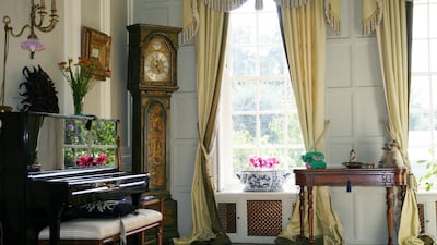 A grandfather clock stands proudly in the corner next to a piano. Courtesy Savallis