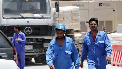 Labourers working outdoors must take extra care to ensure they don't suffer in the summer heat. Pawan Singh / The National