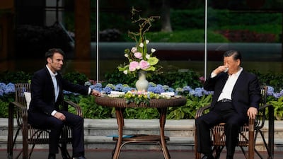 Chinese President Xi Jinping, right, and French President Emmanuel Macron during a tea ceremony at the Guandong province governor's residence on the third day of Mr Macron's visit to China. AFP