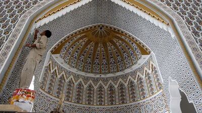 A worker paints in the detail of a groove at the Mehrab in the under construction Al Farooq mosque in Al Safa area in Dubai.