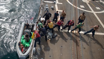 US Navy sailors unload weapons seized from a boat in the Gulf of Aden on to the USS Jason Dunham on August 28, 2018. US Navy via Reuters